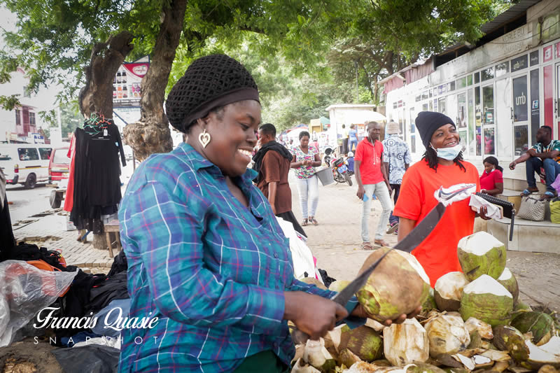 The Female Coconut Seller Captivating Customers with an Exceptional Service